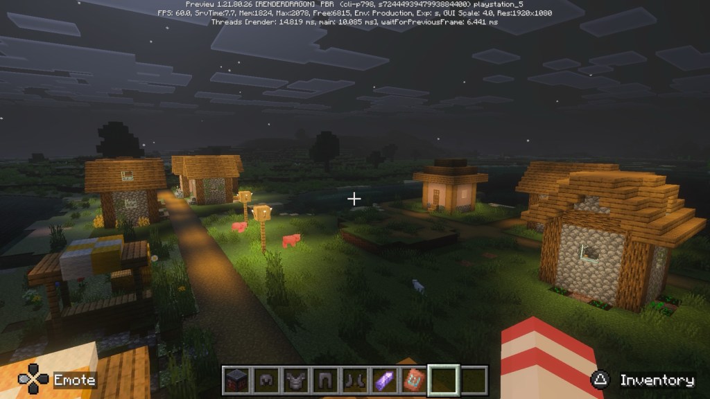 A higher view of a Minecraft village at night with Vibrant Visuals on